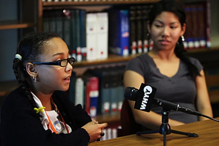 Tamika Miles (left), 11, a sixth grader at Masterman, and Kelly Ca, student-body president, speaking with reporters. Tamika will lead the Pledge of Allegiance for the president's visit. Ca will introduce Obama. (Ron Tarver/Staff)