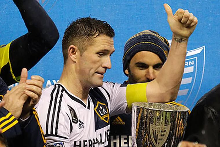 Los Angeles Galaxy forward Robbie Keane celebrates with the Western Conference trophy. (Ted S. Warren/AP)