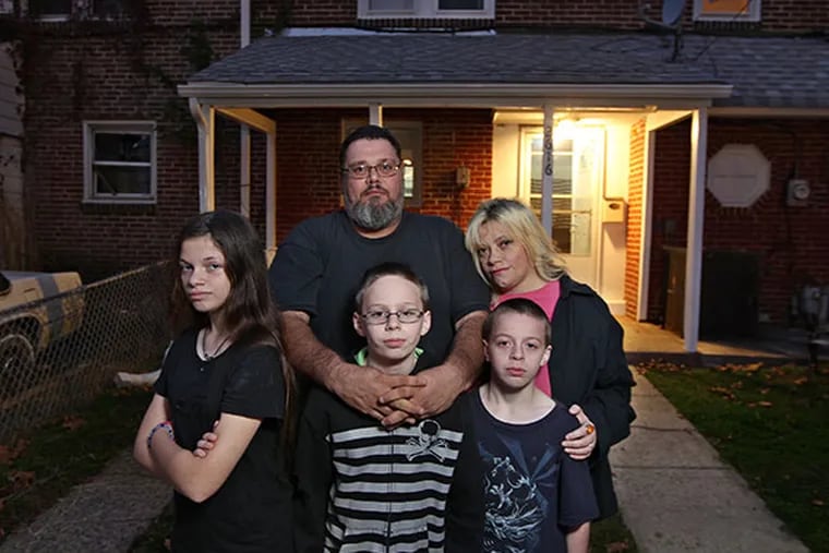 Left to right, front row Sierra Quintiliani, 13, Dylan Blue, 12, and Zachary Blue, 11,  live with their mother Melissa Zirilli, back right, and her husband, Donald Grover, in a rented house in Chester, PA. (MICHAEL BRYANT / Staff Photographer )