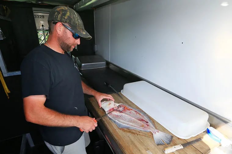 Erik Lund of On the Fly Mobile Fish Cleaning at work. “Everyone tries to cut fish on their own,” the Lower Township resident says. “They think they can handle it, think they can do it. When they see what we do, we clean [the fish] properly and we package the fish nicely.” (TOM BRIGLIA)