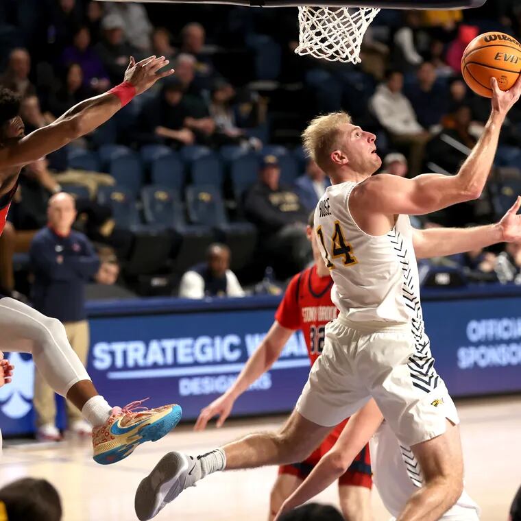 Luke House, right, of Drexel goes up for.a reverse layup against  Stony Brook  during the first half on Feb. 29, 2024.