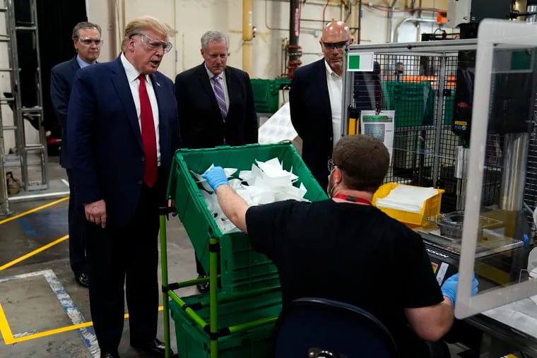 President Donald Trump participated in a tour of a Honeywell International plant that manufactures personal protective equipment Tuesday in Phoenix, with Tony Stallings, vice president of Integrated Supply Chain at Honeywell, right and White House chief of staff Mark Meadows.