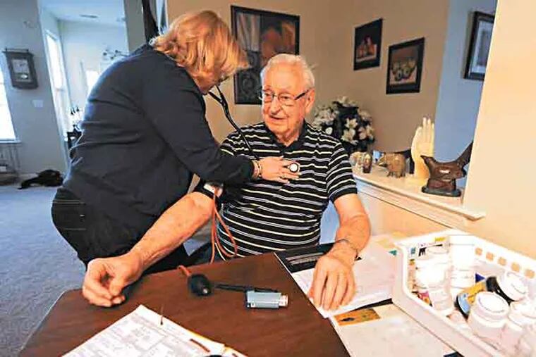 Lisa Doncsecz, RN, clinical team leader with Health Quality Partners of Doylestown, checks the the heart beat of patient Hal Ryan, 88, during an in-home visit on May 21, 2103 at his apartment in Lansdale.  Medicare sponsored 15 programs throughout the country where nurses would visit the homes of the elderly and chronically ill in an attempt to cut down on hospitalizations.  ( CLEM MURRAY / Staff Photographer )