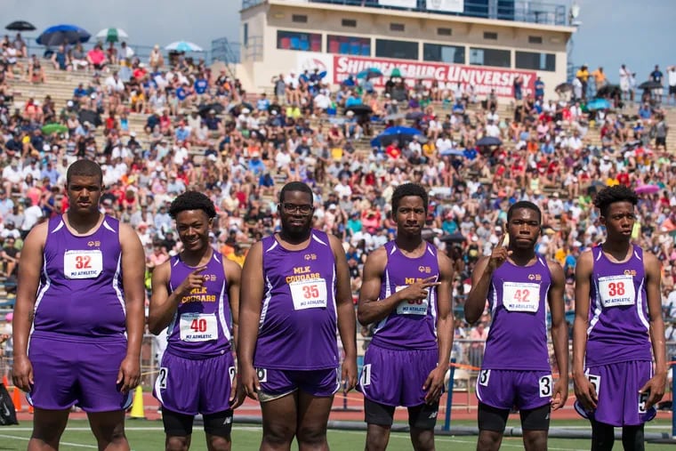 Athletes from Martin Luther King High School stand together following the Special Olympics 100-meter dash at May's state track and field championships.