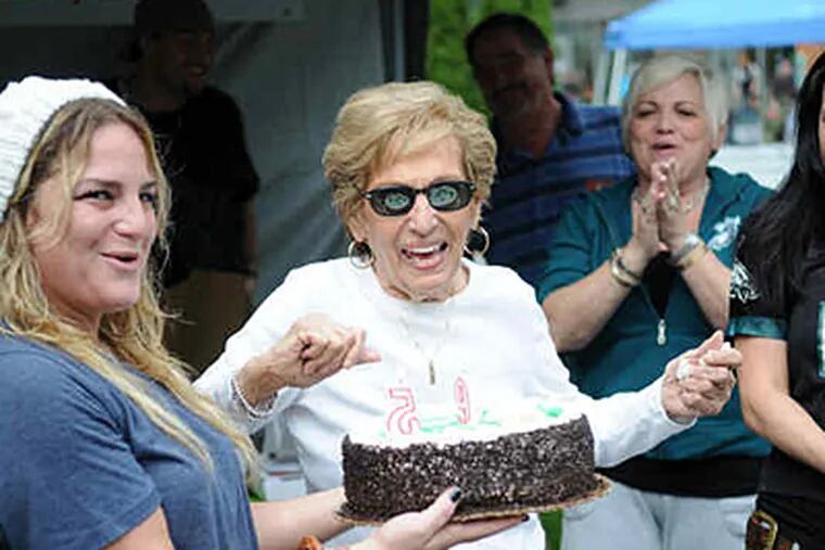 Eagles fan Bianca Antonini (center, with sunglasses), 95, gets a cake from granddaughter Janine Antonini. (Kriston Bethel / Staff)