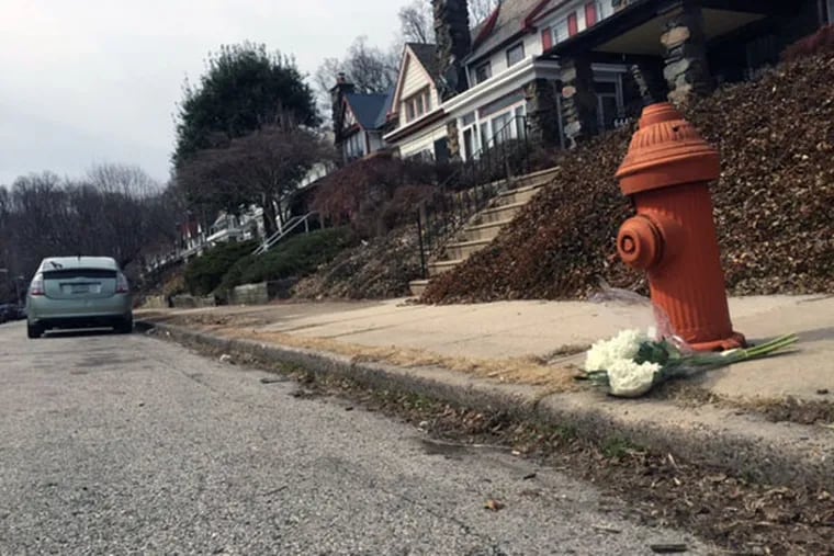 On the spot where James Stuhlman died, someone placed a bouquet of white hydrangeas. (Aubrey Whelan/Inquirer Staff)