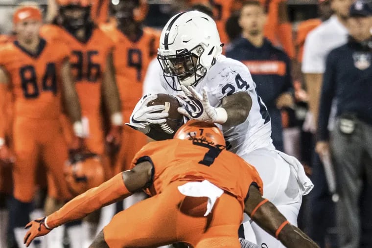 Miles Sanders dodges Illinois' Stanley Green during the second half of the Nittany Lions' win on Friday.