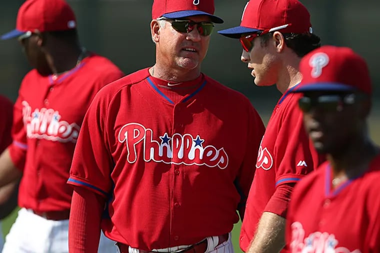 Phillies manager Ryne Sandberg talks to Chase Utley. (David Maialetti/Staff Photographer)