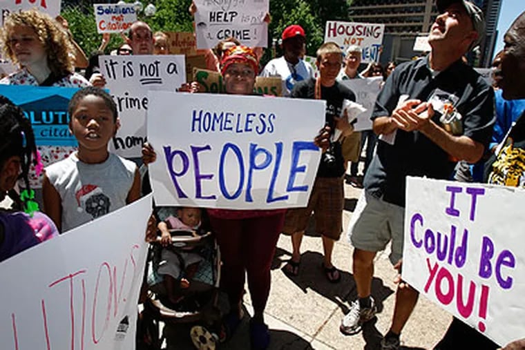 Rachel Franklin, center, who is homeless, joins in a rally protesting Councilman Frank DiCicco's bill  to amend Philadelphia's code as it pertains to sidewalk behavior on Thursday. DiCicco didn't introduce the bill. (David Maialetti / Staff Photographer)