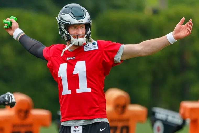 Eagles quarterback Carson Wentz warms up, prior to the beginning of practice, at the NovaCare Center on May 28, 2019. .