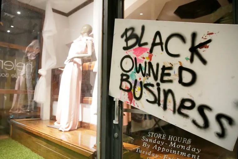 A sign on the front door of Helena's Fashion Lifestyle on Fourth Street in Philadelphia on June 5, 2020.
