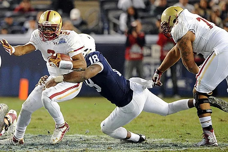Boston College quarterback Tyler Murphy (2) runs with the ball and is tackled by Penn State  defensive end Deion Barnes (18). (Rich Barnes/USA Today)