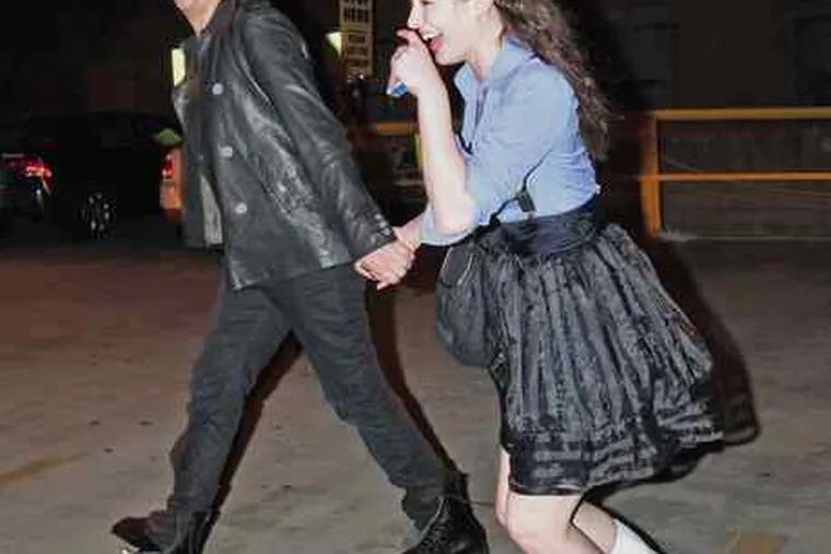 Marilyn Manson and his girlfriend, Stoya, giggle as they flee paparazzi near the Continental in Old City. They were in town Tuesday. Manson will play the Susquehanna Bank Center on Friday as part of the Mayhem Festival.