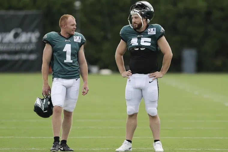 Eagles punter Cameron Johnston (left) and long snapper/holder Rick Lovato talk during training camp at the NovaCare Complex in South Philadelphia on Sunday, July 29, 2018.