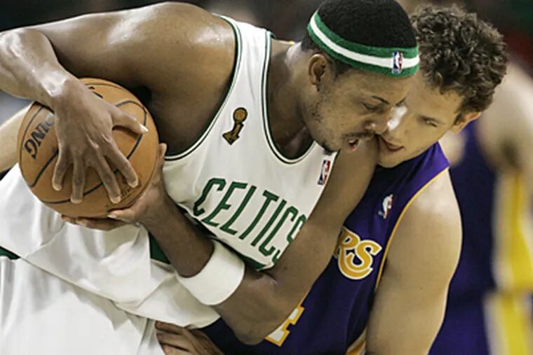The Celtics' Paul Pierce, left, is closely guarded by the Lakers' Luke Walton in the third quarter of Game 2 of the NBA basketball finals Sunday in Boston. (AP Photo/Elise Amendola)
