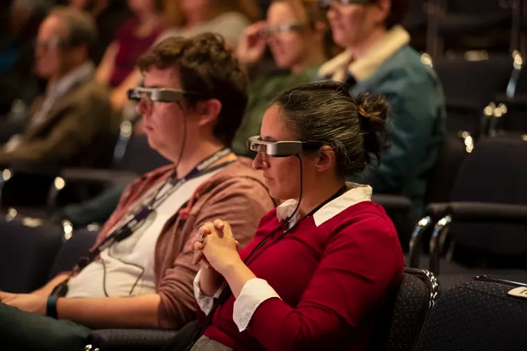 Audience members watching a short scene of the play DOT at The People's Light Theater in Malvern, PA, wearing the new caption glasses that the theater will begin to provide to their patrons with hearing difficulty