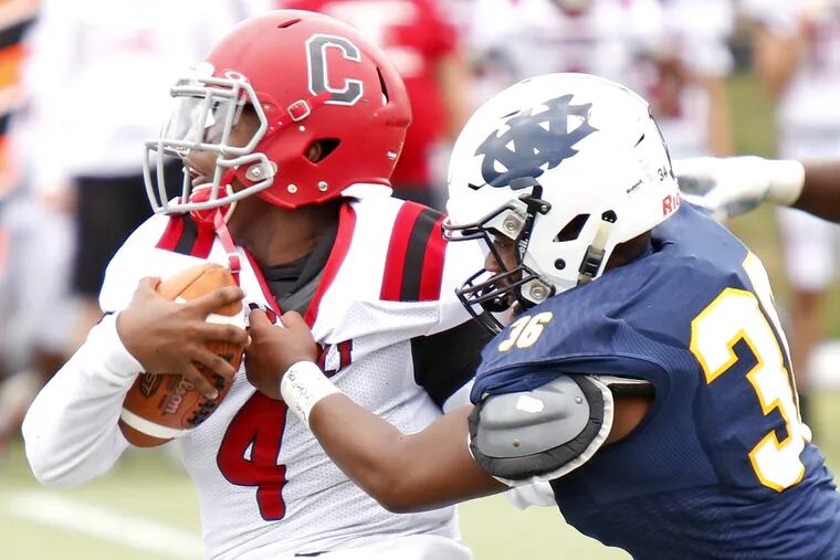 West Catholic defensive back Rodney Washington grabbing Archbishop Carroll quarterback Russell Minor-Shaw during a Sept. 15 game, won by the Burrs.