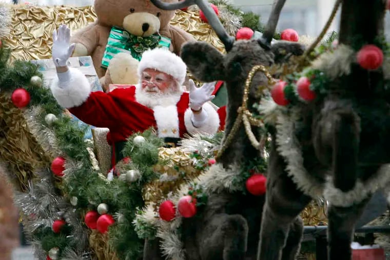 Santa Claus, feeling right at home with Philadelphia's weather, waved to children during Thursday's Thanksgiving Day parade.