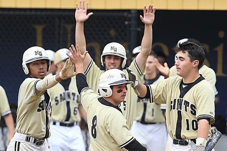 Neumann-Goretti's Joe Lolio is congratulated by teammates Bay To and Nicky D'Amore after scoring in the fourth inning. (Charles Fox/Staff Photographer)