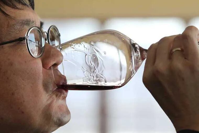 Mark Chien, Penn State Extension viticulture educator, tastes Galen Glen's Crooked Stick Red.   MICHAEL BRYANT / Staff Photographer