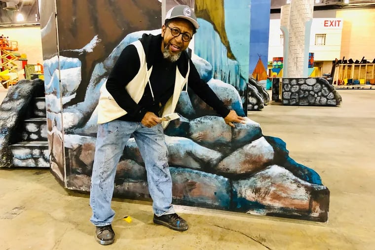African American artist James Dupree shows off scenery he painted for Bill McIntyre's Shooting Stars Fancy Brigade. The club's New Year's Day performance took third place.