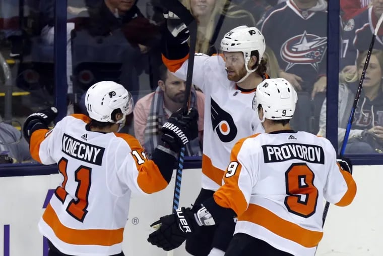 Philadelphia Flyers forward Travis Konecny, left, forward Sean Couturier, center, and defenseman Ivan Provorov, of Russia, celebrate Couturier’s overtime goal agaisnt the Blue Jackets on Feb. 16.