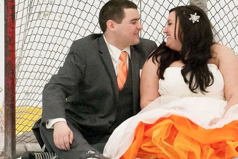 The couple were wed at center ice at Flyers Skate Zone in the Northeast, which is why they are on the ice in the photos. (Chris Hayes Photography)
