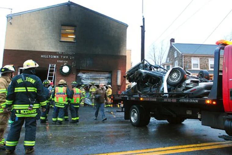 A TOW-TRUCK operator removes a car involved in a fatal accident about 4:15 a.m. yesterday at the Hilltown (Bucks County) Volunteer Fire Company. According to police, the car struck a utility pole, then the front door of the fire station, and burst into flames. The driver, Kyle T. Chorba, 18, of Montgomer y County, was killed.