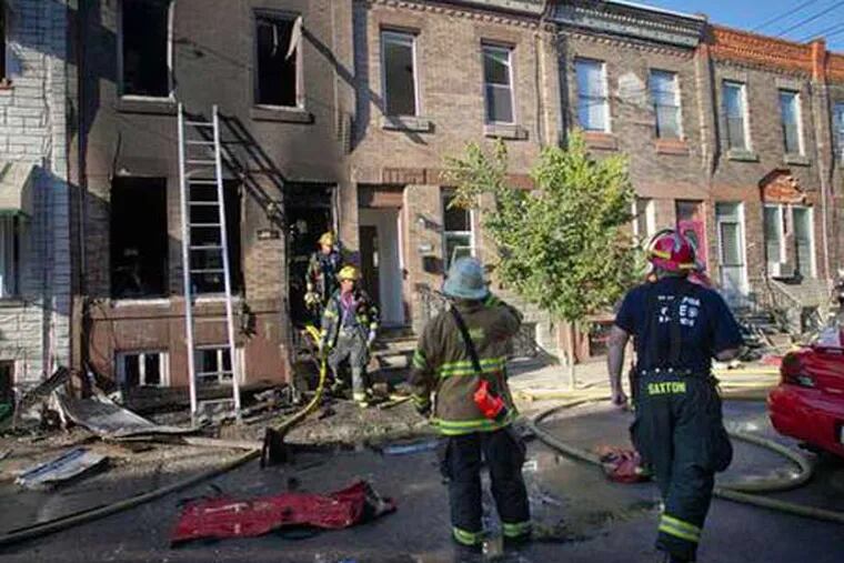 Firefighters respond to the scene of a blaze being investigated as an arson in South Philadelphia. (Alejandro A. Alvarez / Daily News)