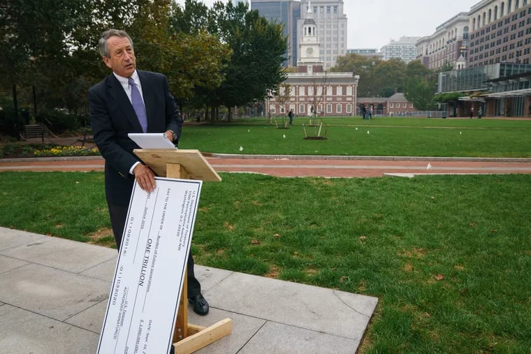 Republican Presidential candidate Mark Sanford places a large check against a podium while preparing for a sparsely attended press conference at the People’s Plaza at Independence National Historical Park and Liberty Bell Center, during Sanford's campaign stop while running for president against Donald Trump, in Philadelphia, October 16, 2019. The check symbolizes Sanford's concern about the federal deficit.