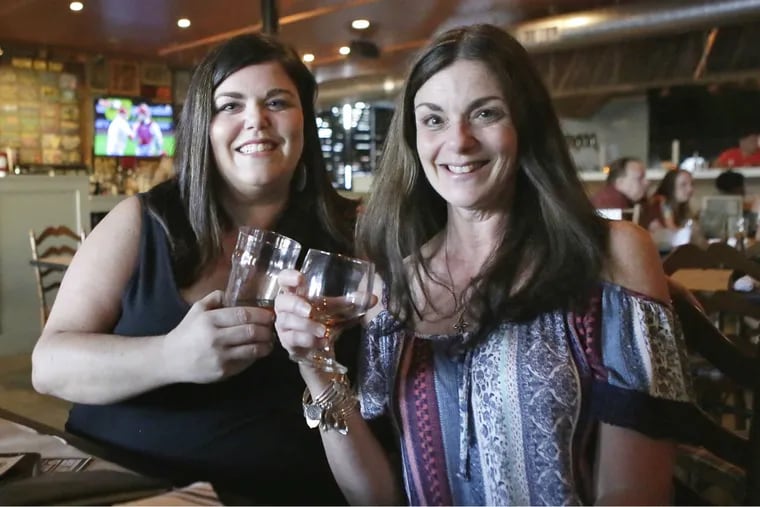 Faye Baptista of Philadelphia (left) and her mother, Kathleen, of Delran, N.J., at a Girls Pint Out meetup in Burlington.