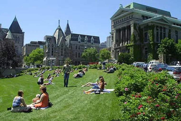 Students sun on the lawn in front of the Redpath Museum on the campus of McGill University in Montreal, where tuition, fees, and room and board run about $21,000 a year. (McGill University photo)