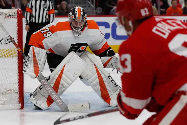 Carter Hart blocks a shot by Red Wings defenseman Trevor Daley in the second period.