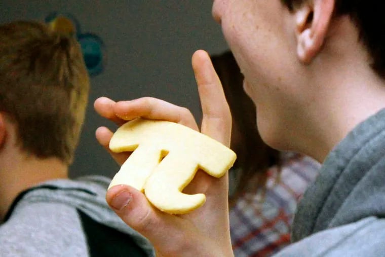 In Livingston, Mont., student David Noble holds a pi-shaped cookie he received for answering a question about the mathematical constant on the eve of Pi Day.