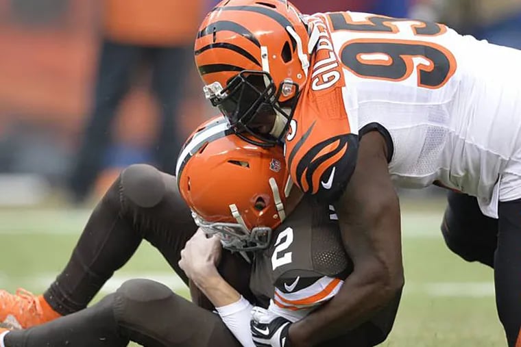 Cincinnati Bengals defensive end Wallace Gilberry (95) sacks Cleveland Browns quarterback Johnny Manziel in the first quarter of an NFL football game Sunday, Dec. 14, 2014, in Cleveland. (AP Photo/David Richard)