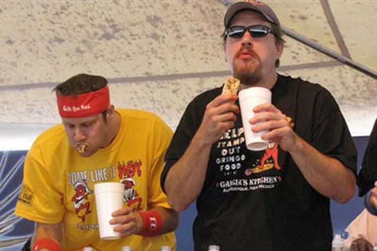 "Humble Bob" Shoudt of Royersford, right, and "Erik the Red" Denmark, compete in the 2009 World Burrito Eating Competition at the New Mexico State Fair in Albuquerque, N.M. on Friday. Shoudt won the contest. (AP Photo/Melanie Dabovich)