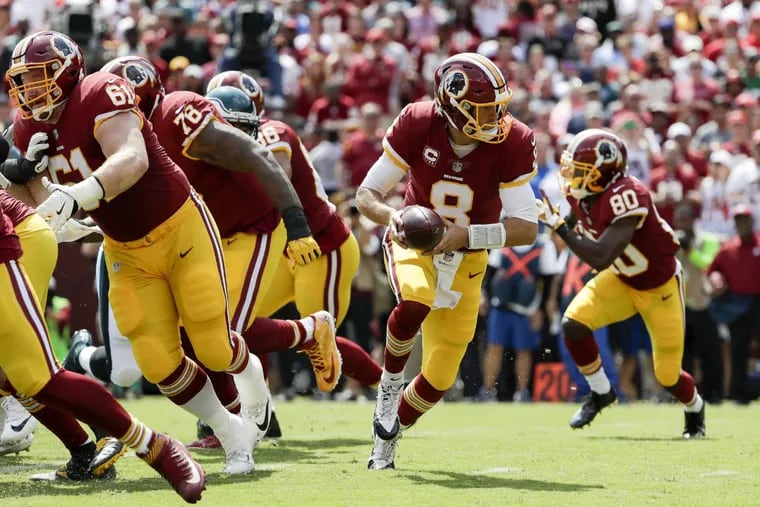 Redskins quarterback Kirk Cousins prepares to hand off l against the Eagles on  Sept. 10.