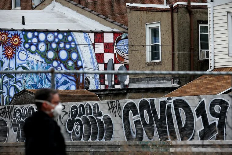 Graffiti that reads "COVID 19" is pictured in Fishtown. As the coronavirus crisis shuts down city schools, thousands of students in Philadelphia, the hometown of the country’s largest internet service provider, are without access to the internet.