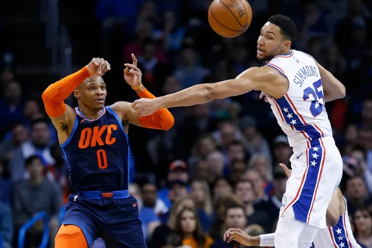 Thunder guard Russell Westbrook (0) passes around 76ers guard Ben Simmons during the first half.