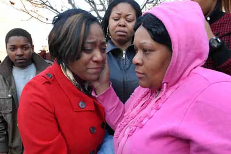 Mourning shooting victim Anjanea Williams, 20, outside her home in Camden are (from left) cousin Deka Carstarphen; aunt Cybill Leggett, who witnessed the shooting; another aunt, Lageria Gulledge; and her mother, LaTonya Williams. (April Saul / Staff Photographer)