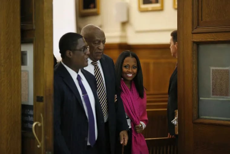 Actress Keshia Knight Pulliam, right, smiles as she walks out of the courtroom with Bill Cosby, center, inside the Montgomery County Courthouse in Norristown, PA on June 5, 2017. Cosby is accused sexual assault.