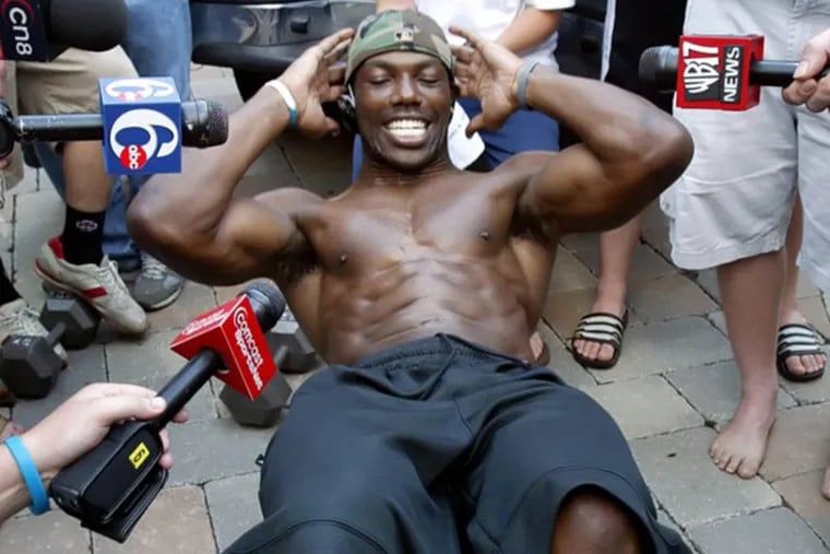 Terrell Owens, banished from training camp for insubordination in 2005, does sit-ups at his home in Moorestown, N.J. for the assembled media.