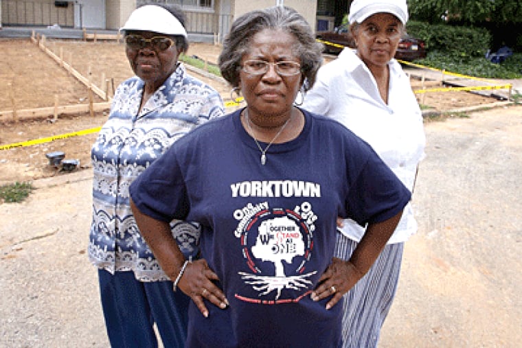 Mary McCrea, left, Renee McNear, center, and Constance Taylor, right, in their Yorktown neighborhood, where the owner of the
house behind them is trying to put in a four-person driveway. (Jessica Griffin / Philadelphia Daily)