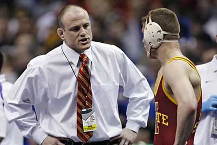 Cael Sanderson, left, gives some last minute advice to his brother Cyler Sanderson, while at Iowa State. (AP Photo / Tom Gannam)