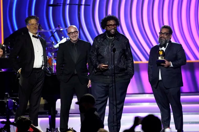 Robert Fyvolent, from left, David Dinerstein, Questlove, and Joseph Patel accept the award for best music film album for "Summer Of Soul" at the 64th Annual Grammy Awards on Sunday, April 3, 2022, in Las Vegas. (AP Photo/Chris Pizzello)