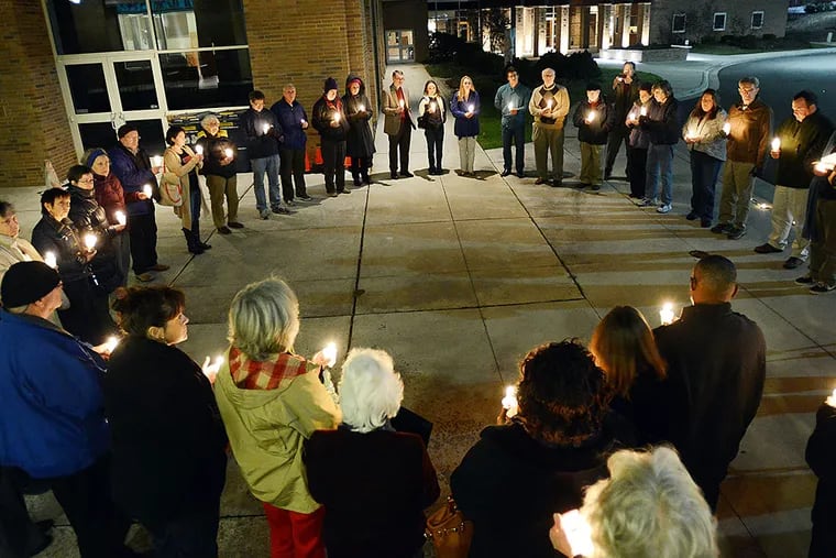 A vigil at a synagogue in Durham, N.C., is held to commemorate the second anniversary of the Sandy Hook Elementary School shootings. BERNARD THOMAS / The Herald Sun