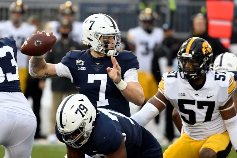 Penn State quarterback Will Levis passes as Iowa defensive lineman Chauncey Golston (57) closes in on Saturday.