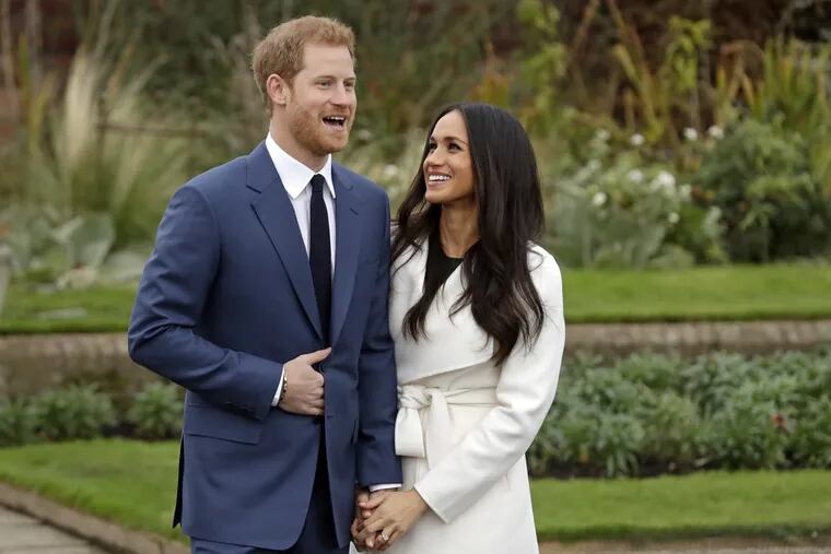 Britain’s Prince Harry and his fiancee Meghan Markle pose for photographers during a photocall in the grounds of Kensington Palace in London, Monday Nov. 27, 2017. Britain’s royal palace says Prince Harry and actress Meghan Markle are engaged and will marry in the spring of 2018. (AP Photo/Matt Dunham)
