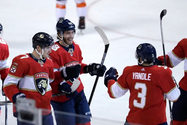 Florida's Mike Hoffman (68) celebrates with his teammates after scoring an empty-net goal late in the third period to put the Panthers up 5-2 over the Flyers.