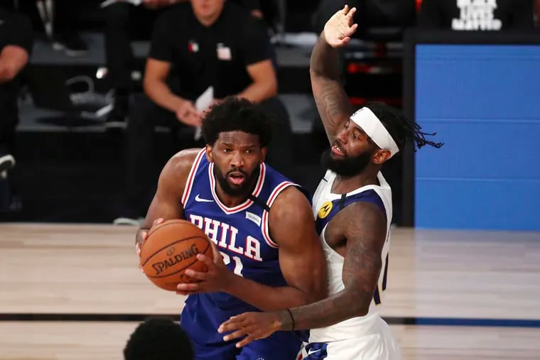 Sixers center Joel Embiid  drives to the basket against Indiana Pacers forward JaKarr Sampson during the third quarter Saturday.